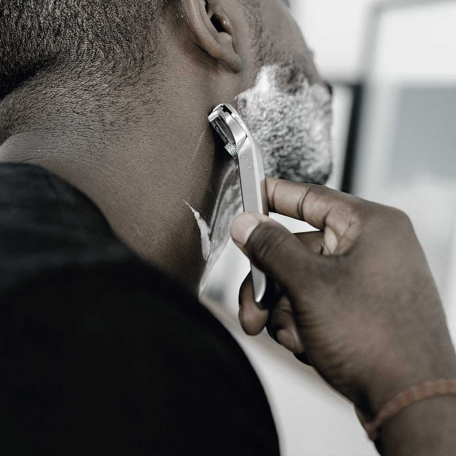 Man shaving his neck with a safety razor